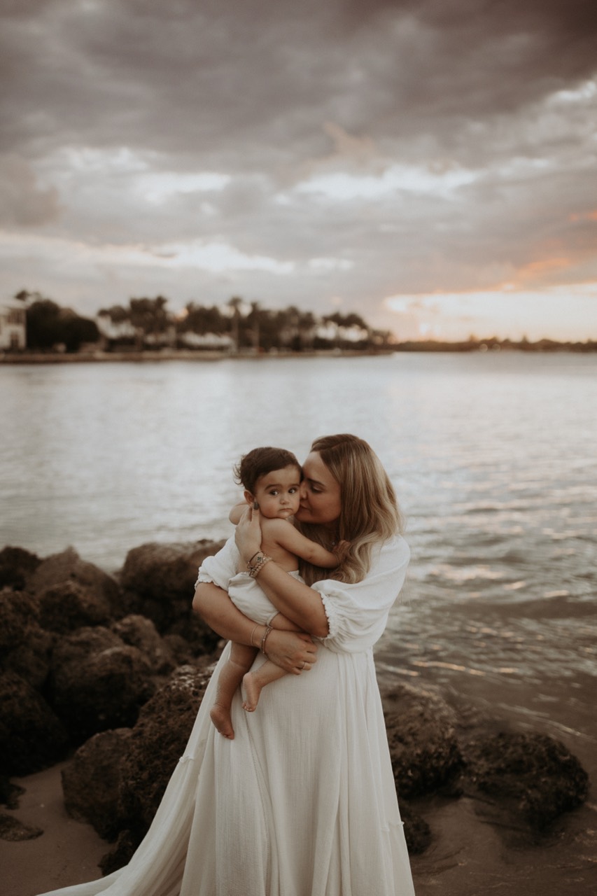Taliya Corbett holding her baby by the water